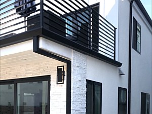 Black fascia with black custom smooth and round downspouts